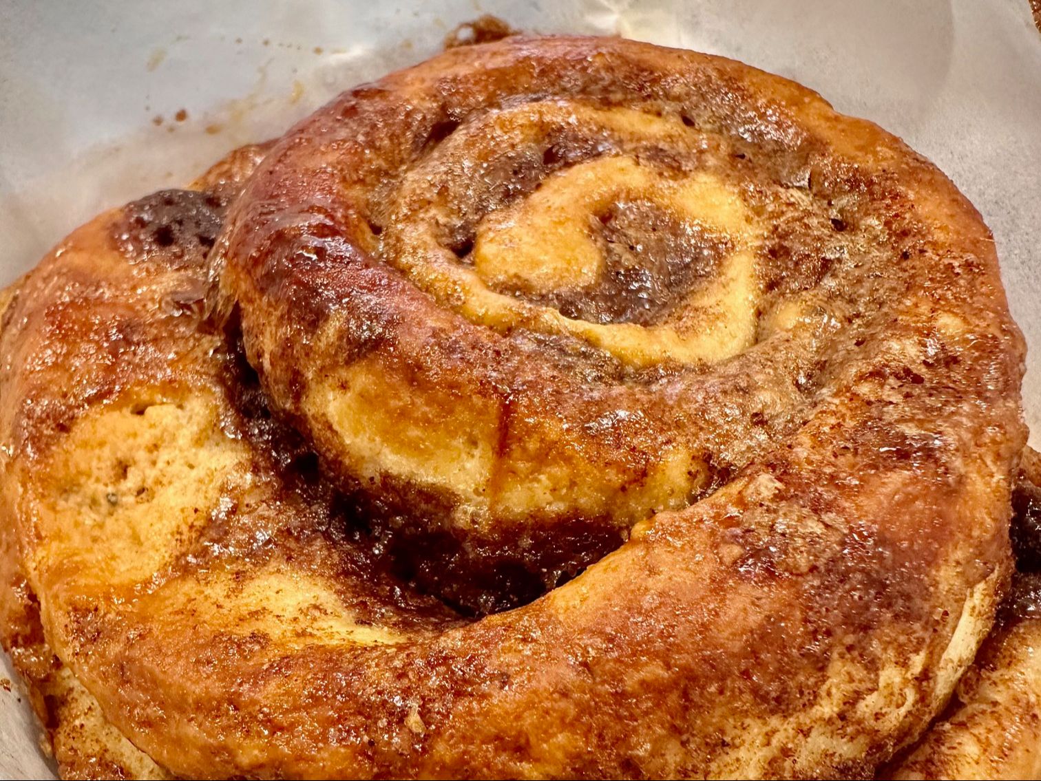Cinnamon square with glossy baked cinnamon swirls