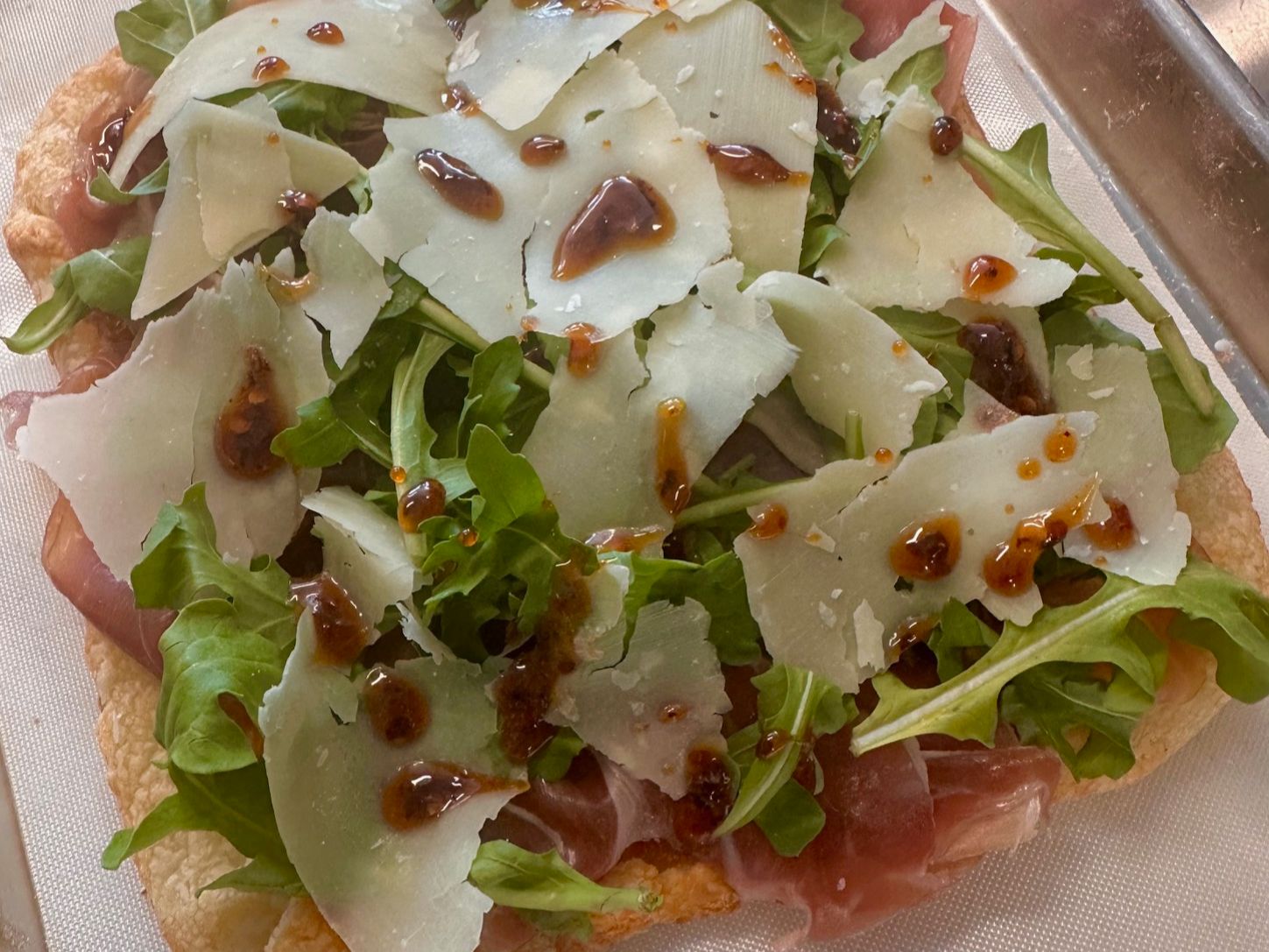 Prosciutto pizzetta with arugula, parmigiano and spicy honey