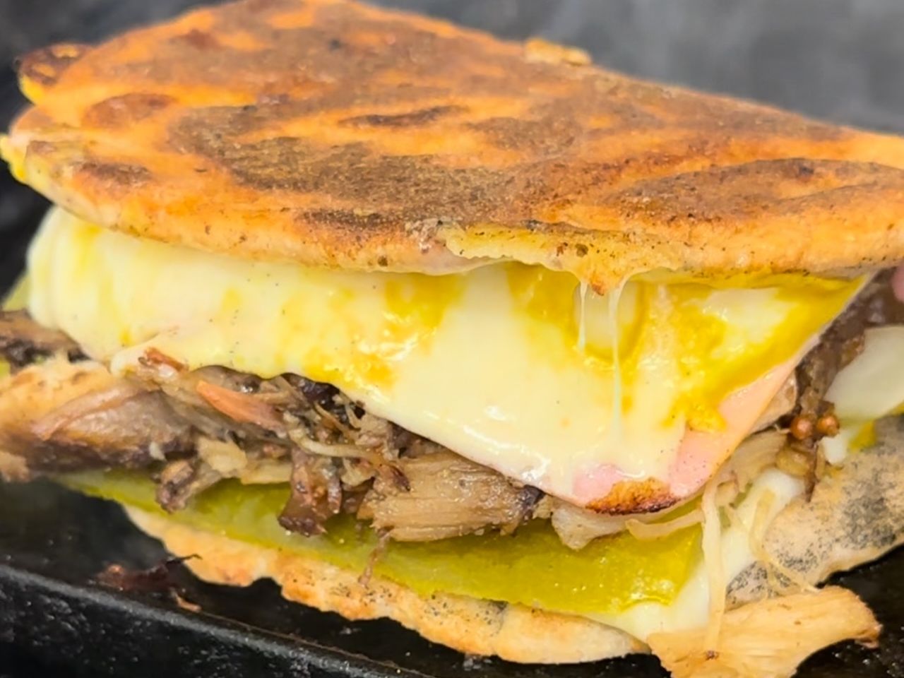 Sanduche Cubano with melted cheese and pressed bread